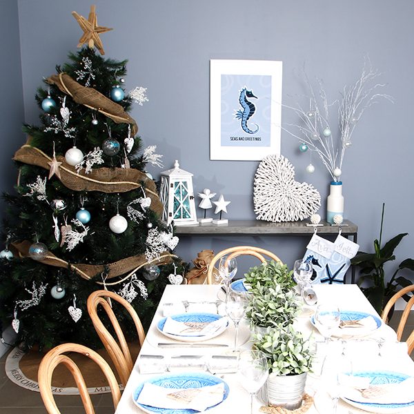 Hamptons - Christmas Tree and Dining Table Set with a Sea Horse Poster Hanging in the wall