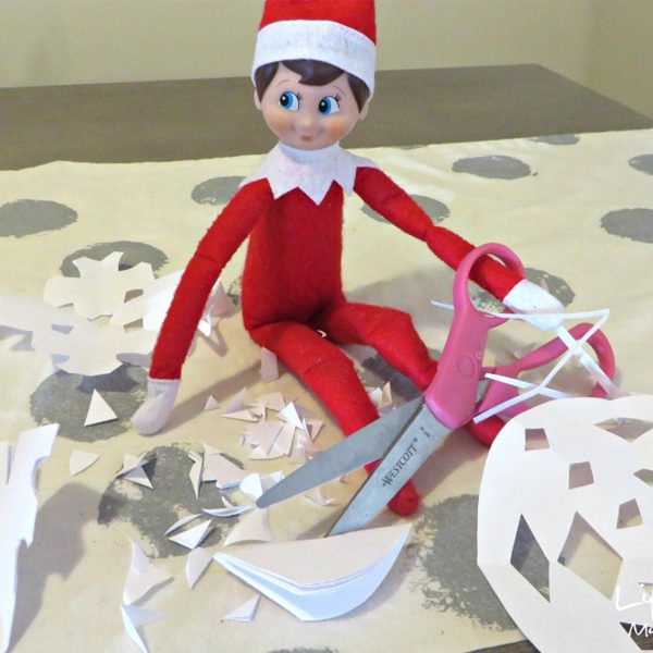 Elf Cutting Snowflakes Paper with Scissors