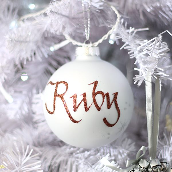 Pastels and Pearls and silver bauble named Ruby Hanging in a white Christmas Tree