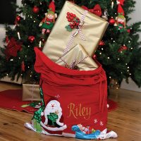 Deluxe Santa Sack Sack Named Riley With Presents Inside Infront of the Christmas Tree