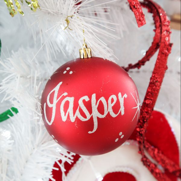 Personalised Red Bauble Named Jasper hanging in a White Christmas Tree