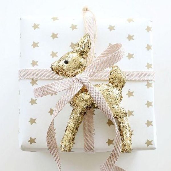 Gift wrapped in white with little stars - ribbon and golden Deer added