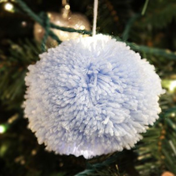PomPom Bauble Bluish Colour Hanging in a Christmas Tree