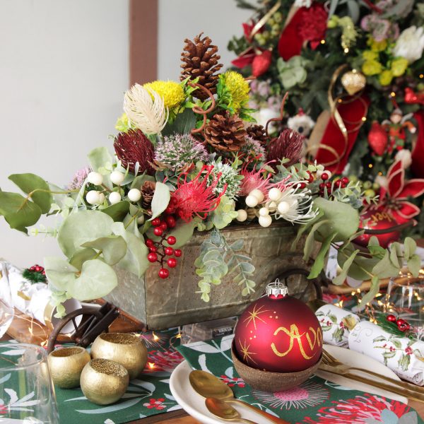 Bush Christmas Table Dining Table Floral Decorations and Holly and Gold Trim Bon Bons with Berry and Fir and Personalised Red Glass Bauble
