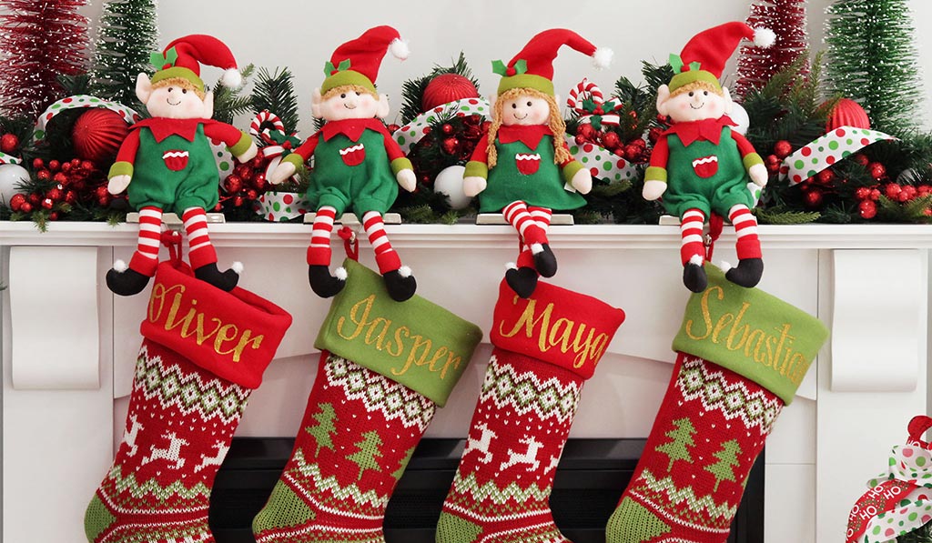Personalised Christmas Stockings Hanging in the Fire place with the Elf Stocking holder