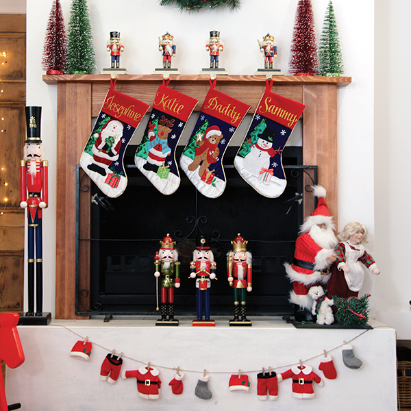 Felt Santa Clothes Garland Stocking hanging in fire place in the living room