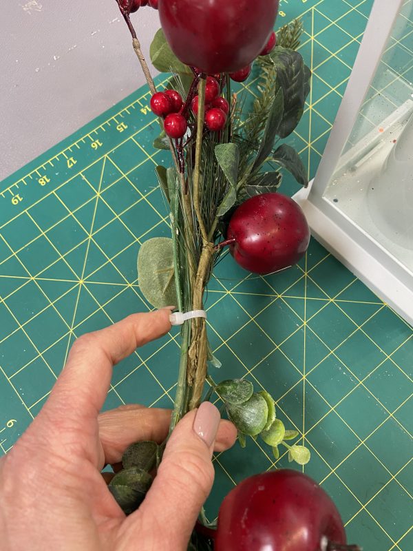 Tying the Christmas Garland with Red Berry