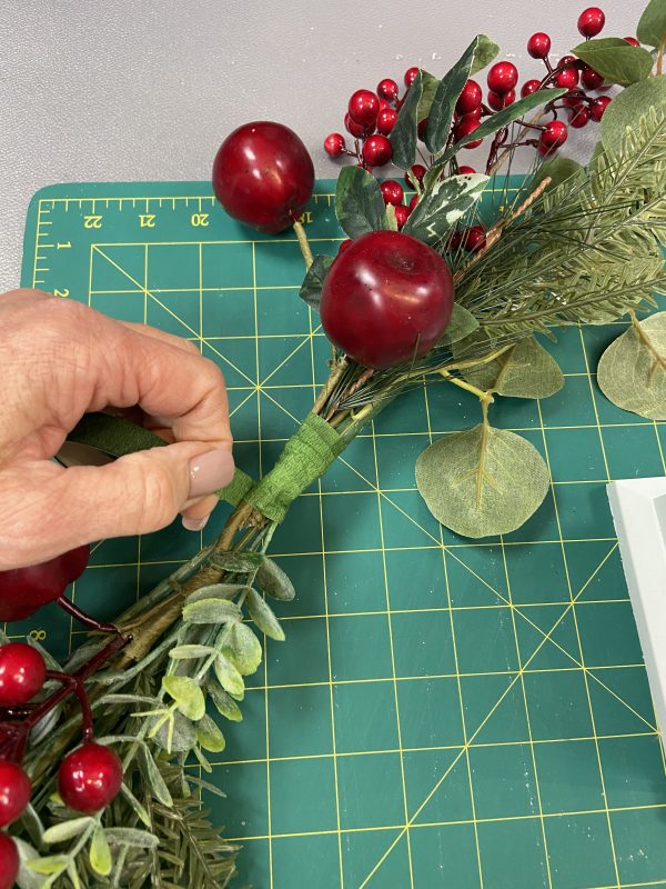 Tying the Red Berry and Apple Christmas Garland