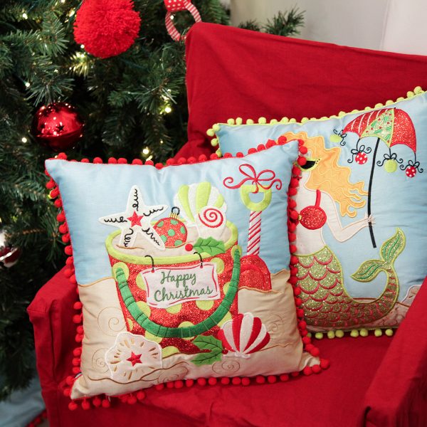 Pom Pom Beach Cover Cushions in Room and also a Pom Pom Mermaid Cusion placed in a chair beside the Christmas Tree