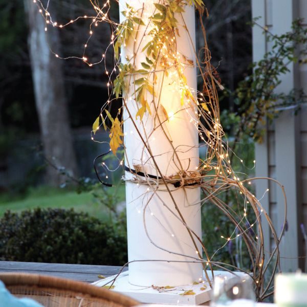 How to Incorporate Christmas Décor Copper Seed Fairy Lights wrapped in the terrace posts with vines and leaves around