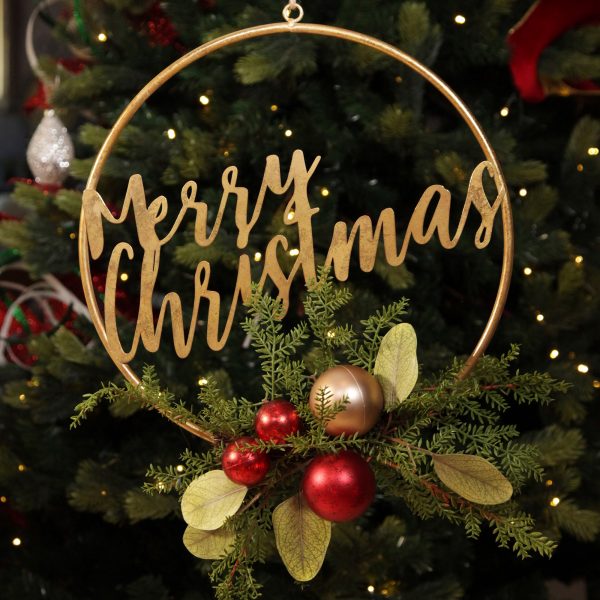 A Christmas Kitchen Merry Christmas Metal Hoop with Florals hanging on a Christmas Tree