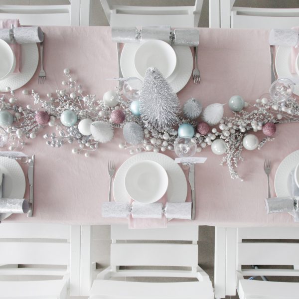 Pretty Little Christmas Table Decorations and Plate Set in the living room with plates and spoons and light pink tablecloth