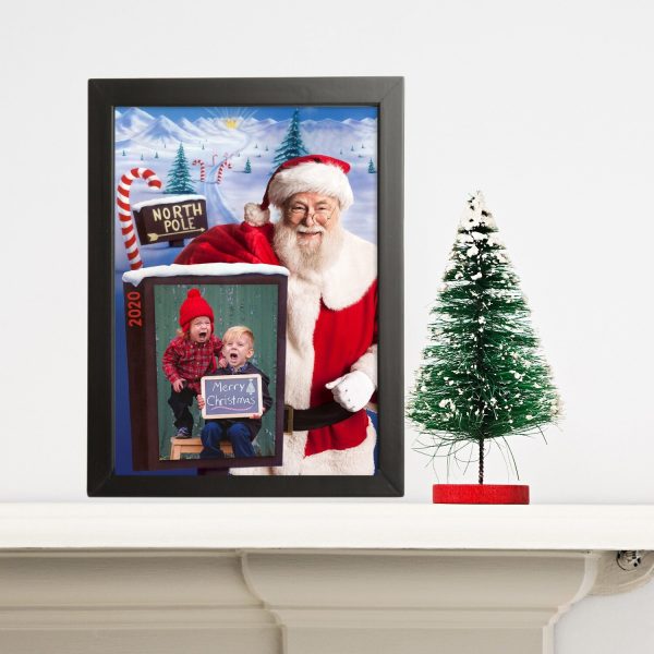 Stay at Home Santa Photo North Pole with a book with 2 kids crying and a small table top tree beside