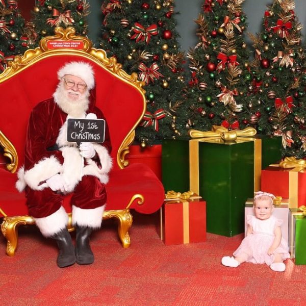 Narellan Town Centre Santa Photo with little girl sitting in the corner smiling