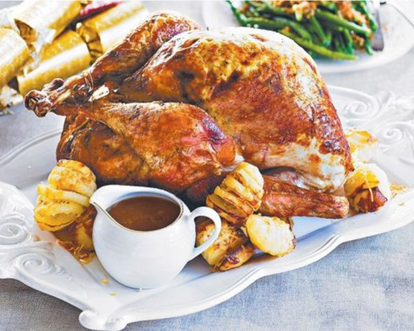 Traditional Turkey with a Twist with potato and gravy placed in a big tray
