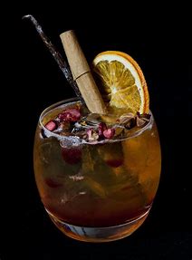 Christmas Pudding Cocktail with lemon placed in a blackground
