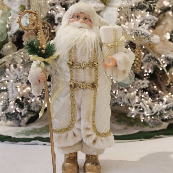 Ivory Gold Standing Santa Christmas Ornament Infront of a huge Christmas Tree