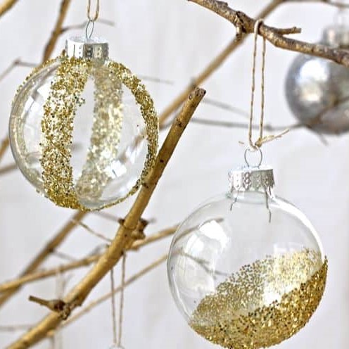 Golden glitter in a bauble hanging in a Tree Branch