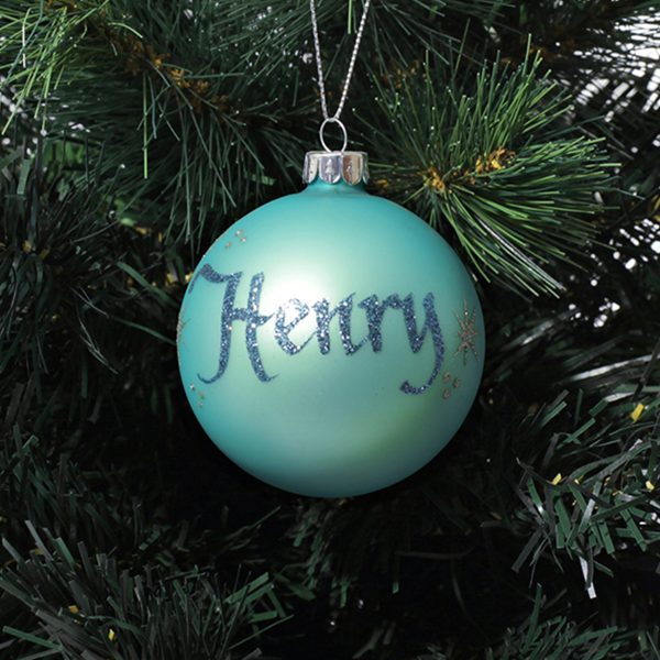 Sky Blue Glass Personalised Christmas Bauble Hanging in a Christmas Tree