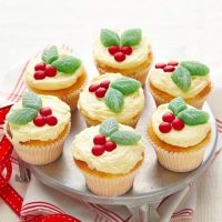 Holly Cupcakes with green mint and red berry on top placed in a silver tray