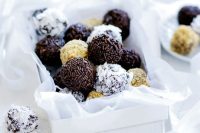 Chocolate Fruitcake Rum Balls placed in a paper box