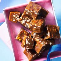 Pecan Fudge placed in a box sliced in square
