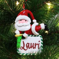 personalised santa with plaque decorstion hanging in a Christmas tree