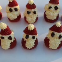 Santa Strawberries with white icing placed in a white tray