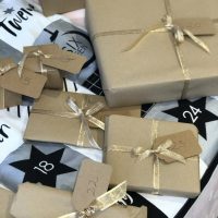 Gift boxes wrapped in golden ribbon placed in a clothe calendar