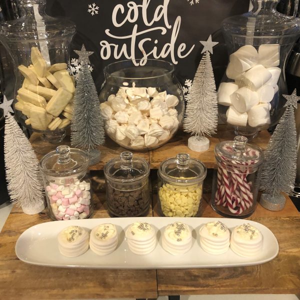 Hot chocolate Bar with different treats added in the jar and table top trees