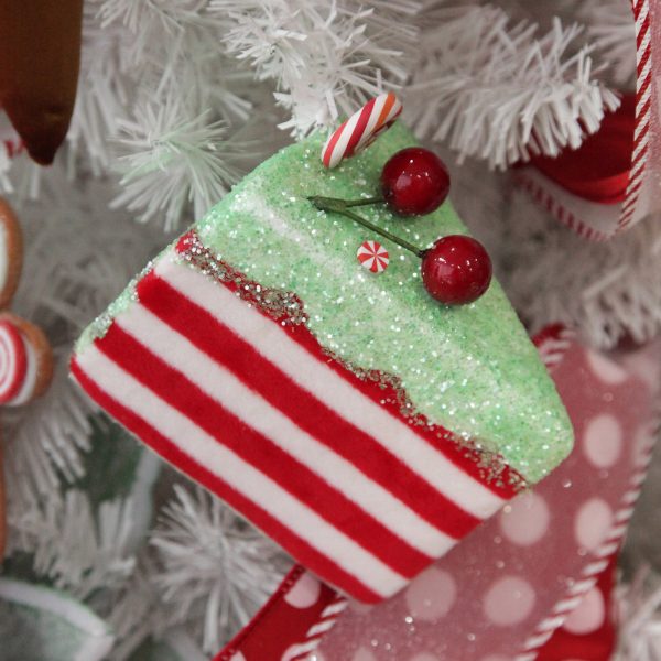 Sweet gingerbread christmas tree candy cane and mint velvet cake slice