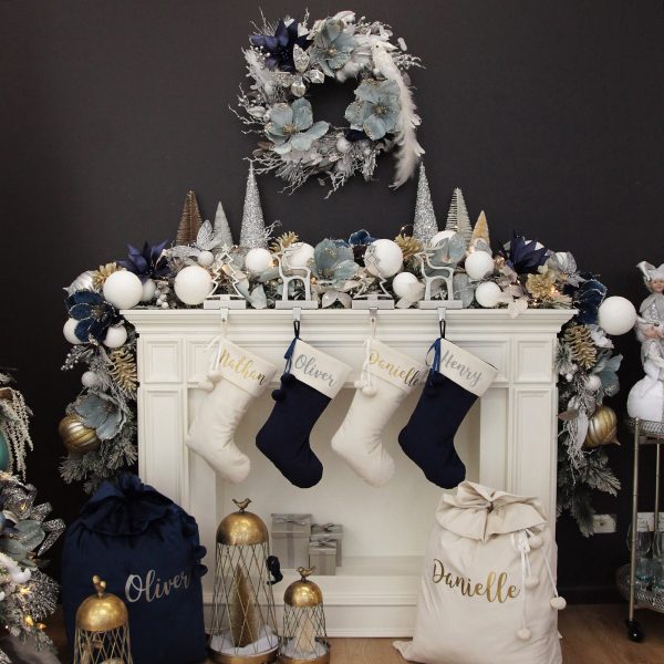Coastal Chic Christmas mantel with blue and White Christmas Stockings Hanging Infront of the Fireplace