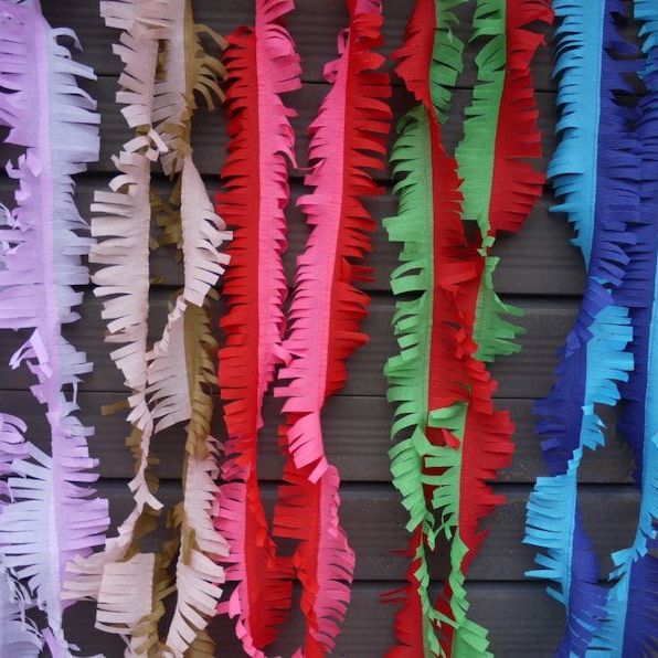 Colourful Paper Tinsel Hanging in the Wooden Wall