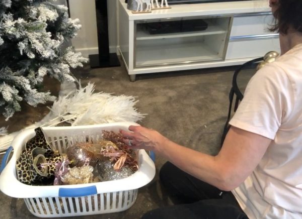 Packing Away - Deb Taking the Decoration inside the white basket