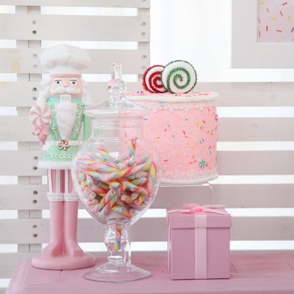 Chrsitmas Sprinkles Table with Santa Nutcracker and Candies on a Jar with a Cake Decor
