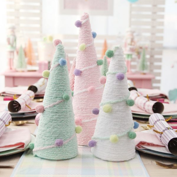 Pom Pom and Wool Cone Trees Christmas Craft Placed in a table