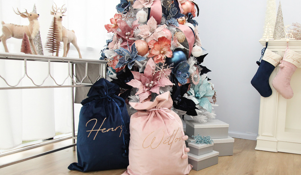 Blush Blue Christmas Feature - with Christmas Stockings hanging and sacks placed infront of the christmas tree