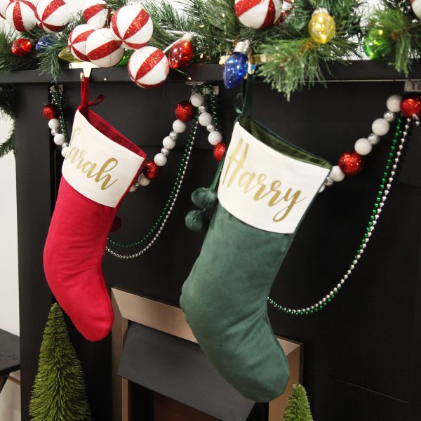 Personalised Forest Green Velvet Christmas Stocking Hanging in a fire place