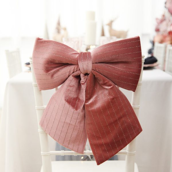 Pink Padded Velour Bow with Glitter Placed in a Chair