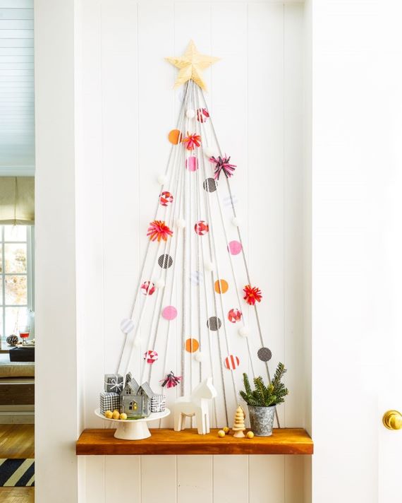 DIY Christmas Tree placed on a wall with diferrent ornaments
