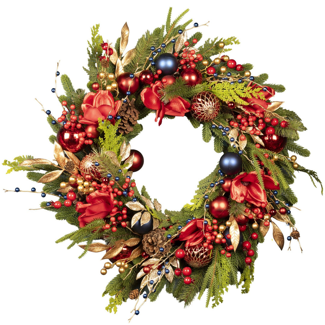 Decorative Christmas wreath with greenery, red ribbons, and ornaments on a white background