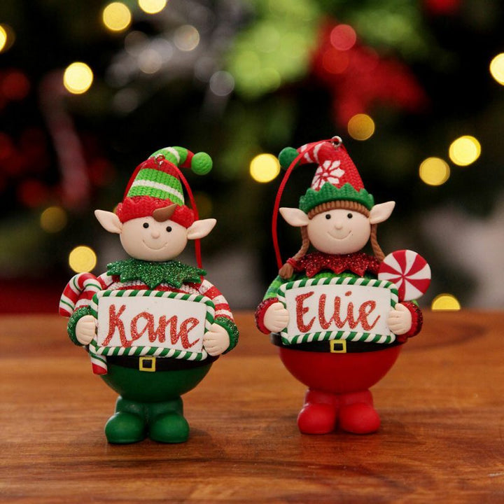 Personalised girl elf and boy elf Christmas ornaments displayed together