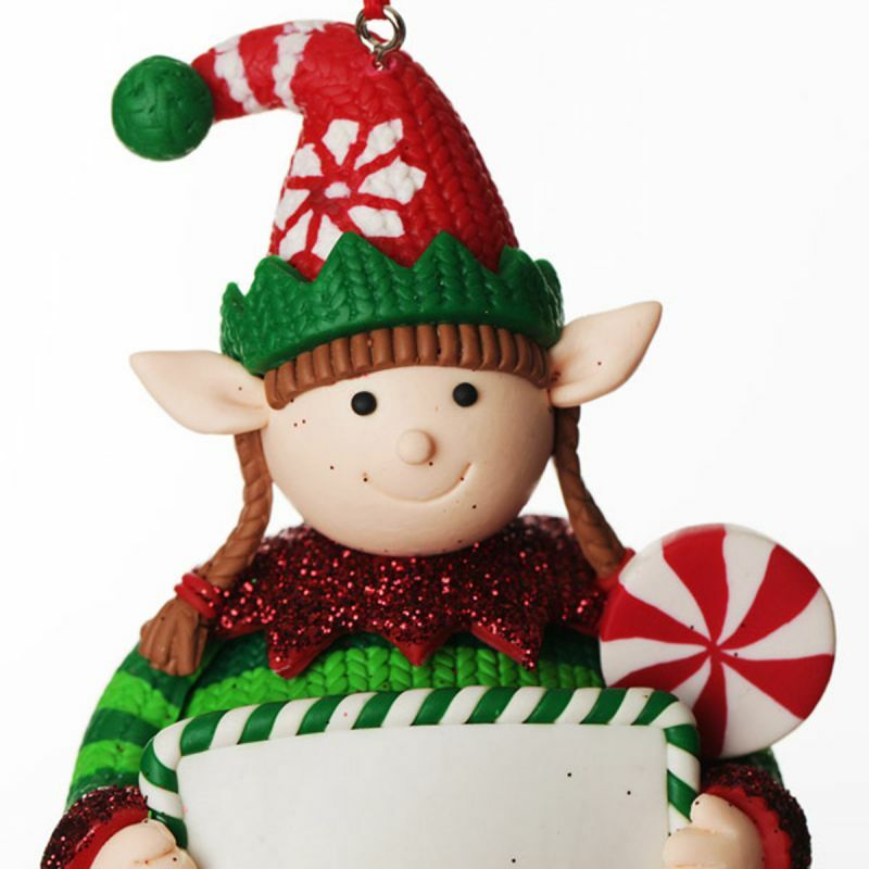 Close up of hand-sculpted polymer clay girl elf with plaits and lollipop