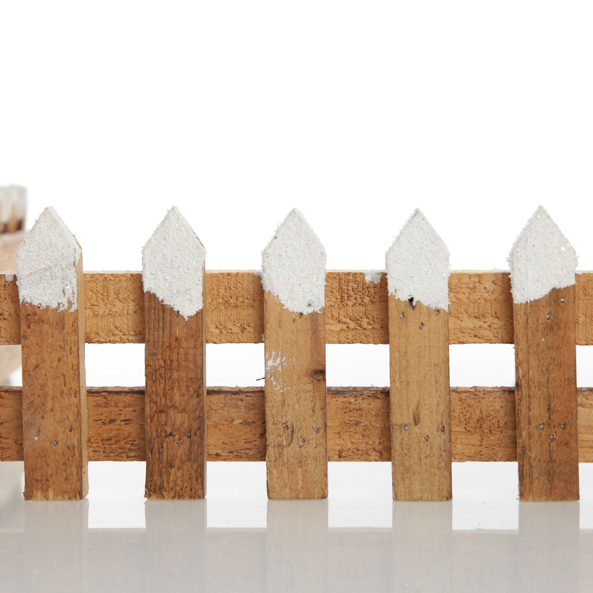 Short Snow Capped Natural Wooden Picket Fence