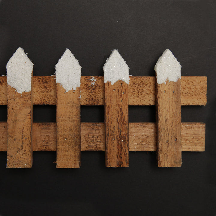 Short Snow Capped Natural Wooden Picket Fence